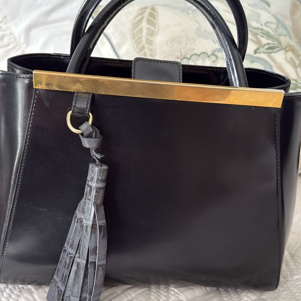 Black and Gold Satchel with Structured Design and Tassel